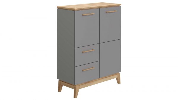 Das PAIDI Highboard Sten ist ein moderner Schrank mit einer Platte und Beinen aus hellem Holz. Es hat vier mattgraue Türen mit Holzgriffen, die in zwei Reihen und zwei Spalten angeordnet sind.
